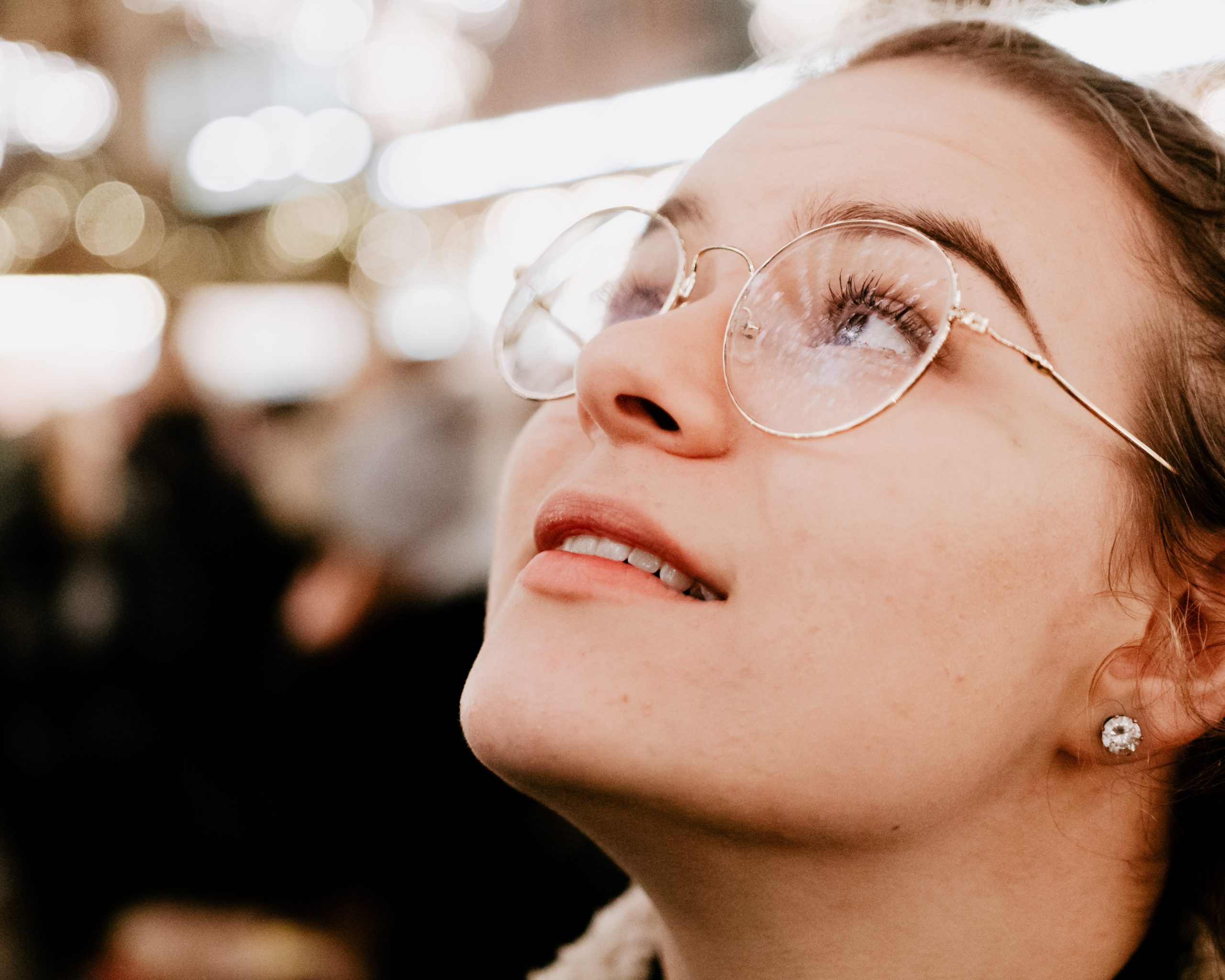 Close-up of woman wearing clear-framed glasses.