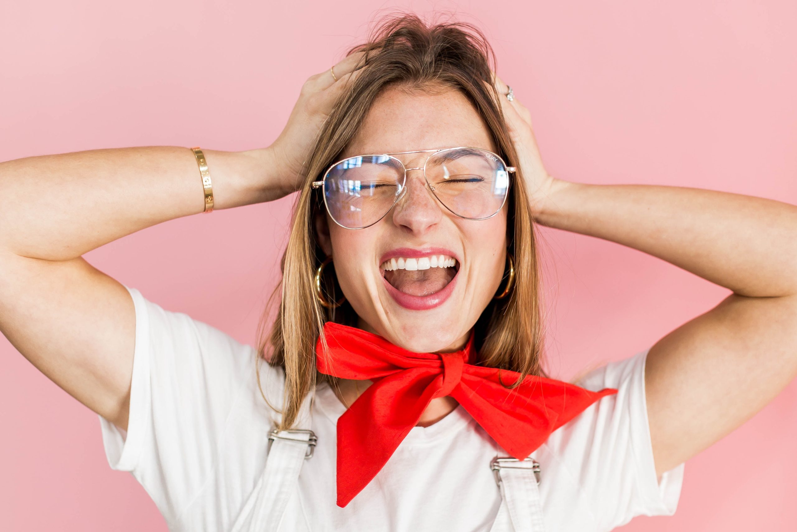Woman wearing glasses smiling widely