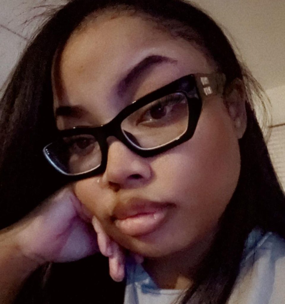 EZContacts customer wearing Miu Miu MU 03XV oversized black eyeglasses