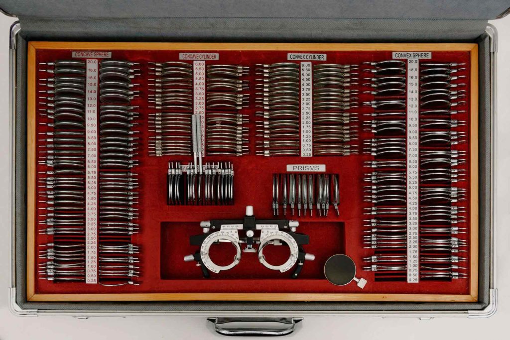 Frames and lenses used for vision testing, neatly arranged in a case