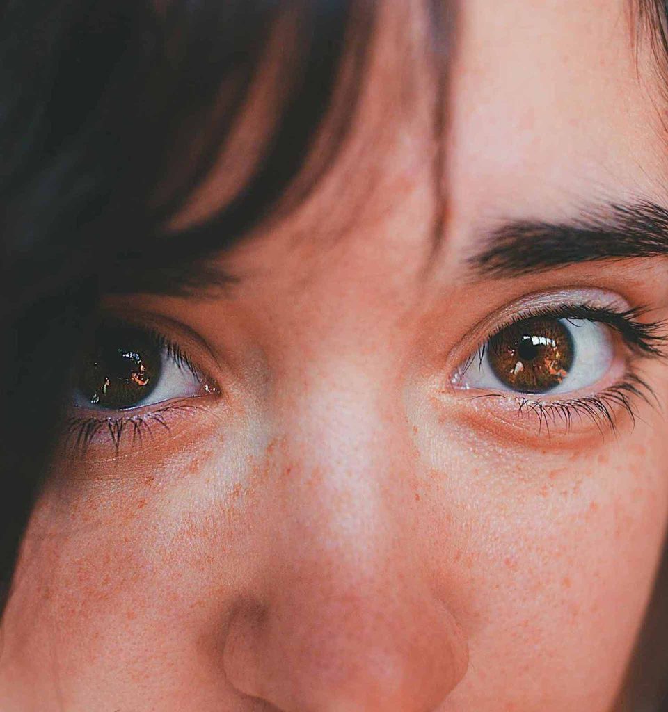 Close-up of brown eyes with natural lighting, highlighting the importance of the eyes