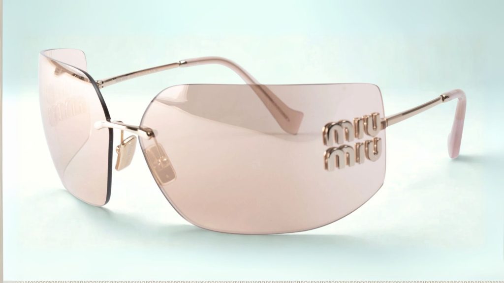 Miu Miu MU 54YS sunglasses featuring pink lenses. gold frames and a Miu Miu logo on the arm