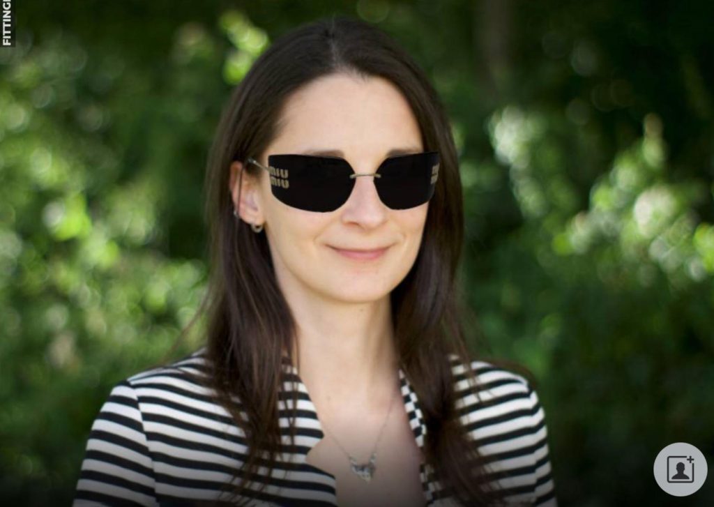 The same woman virtually "wearing" Miu Miu MU 54YS sunglasses featuring gold metal frames and dark grey lenses