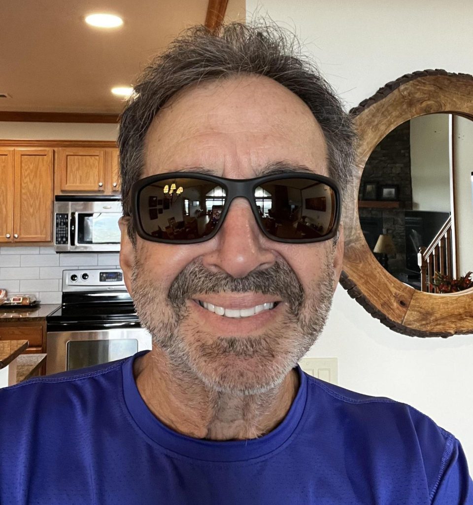 EZContacts customer wearing Maui Jim Kanoio Coast black square sunglasses with tinted lenses