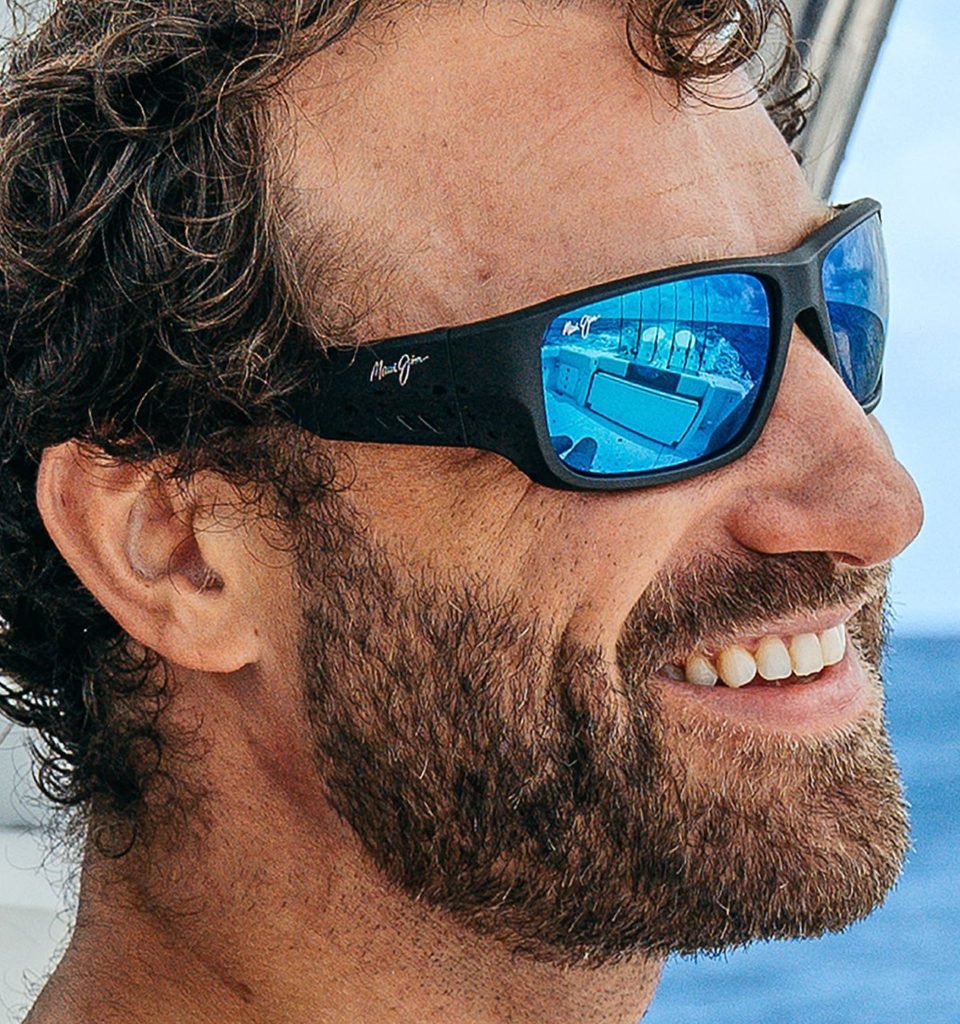 Sailor wearing Maui Jim Keha wrap around sunglasses featuring blue polarized lenses