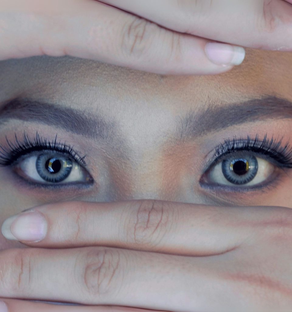 Close-up of a woman wearing blue contact lenses and bold eye makeup