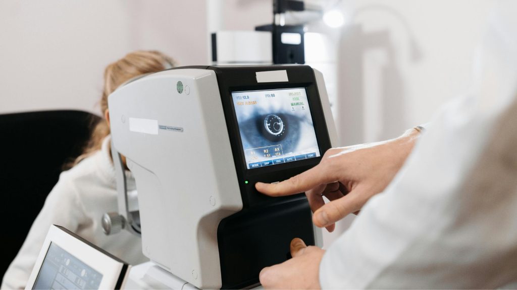 A doctor using an autorefractor to determine a patient’s prescription