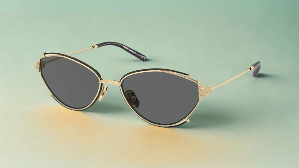 Tory Burch TY6103 cat-eye sunglasses featuring thin gold and black metal frames and grey lenses
