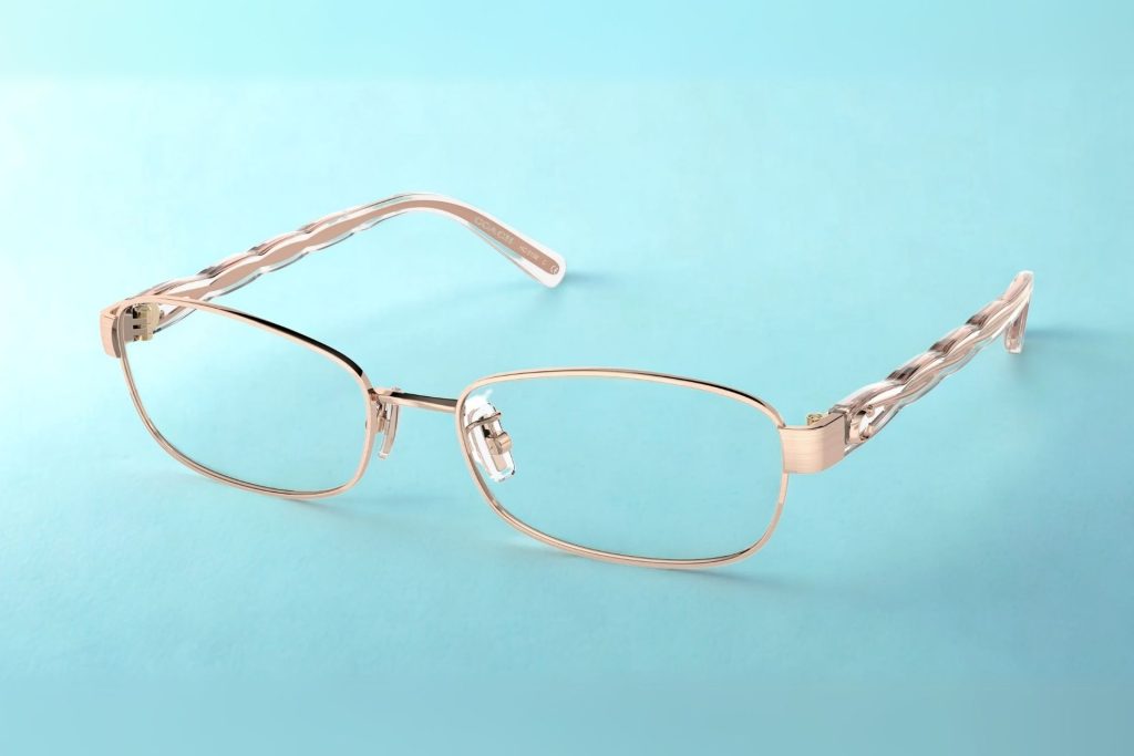 Coach rectangular Brushed Rose Gold metal eyeglass frames featuring elegant, subtle curved detailing running on the arms
