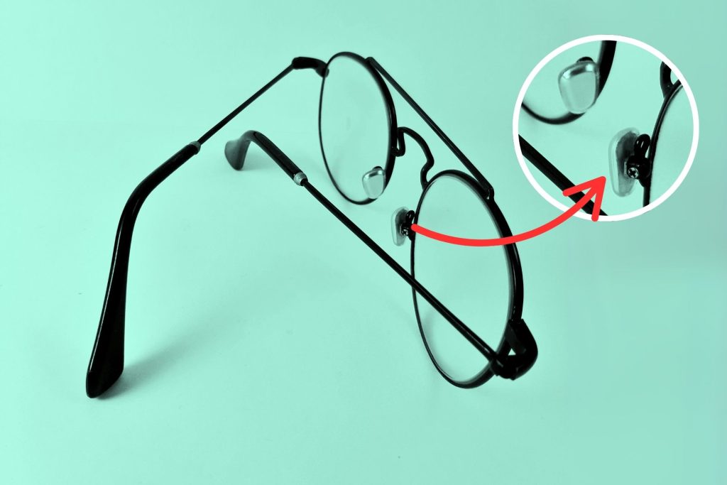 A close-up look at nose pads attached to black wire eyeglass frames