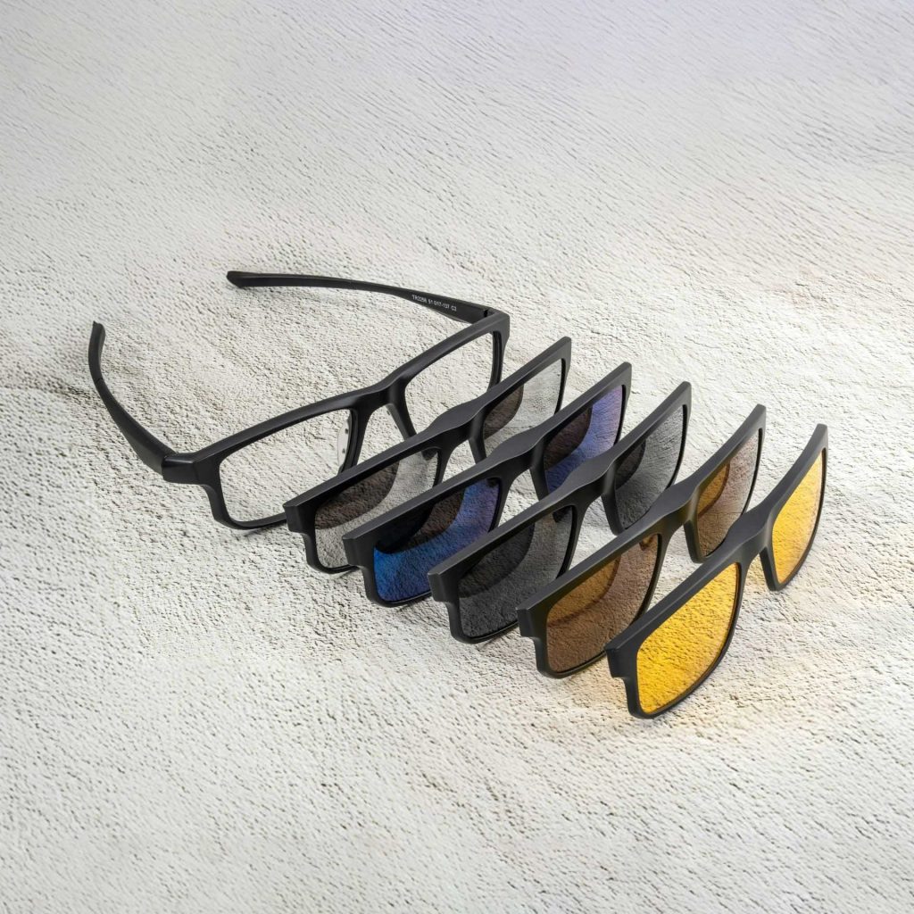 Black plastic glasses with matching sunglass clip-ons in multiple tint colors