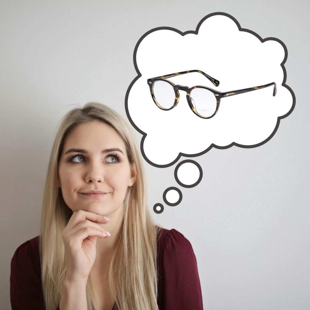 A woman sits with her hand on her chin, while a bubble above her head shows her thinking about a pair of Oliver Peoples glasses.