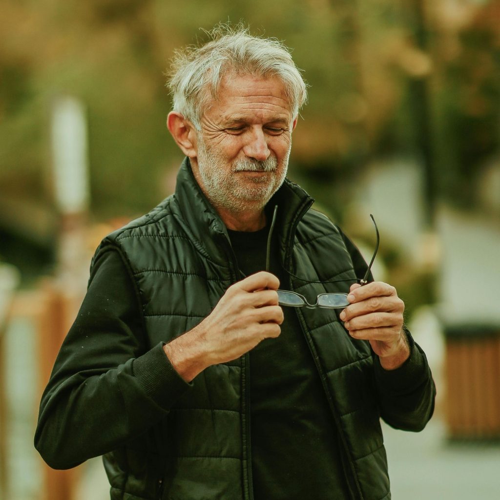 Man holds fogged-up glasses