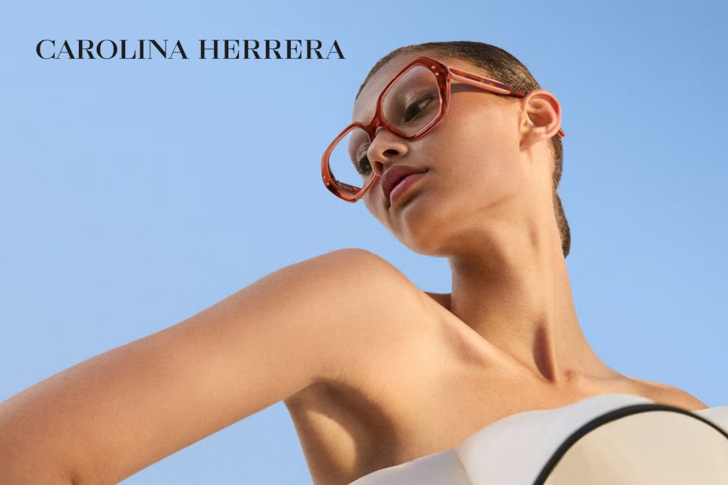 Model wearing red, oversized, geometric Carolina Herrera glasses