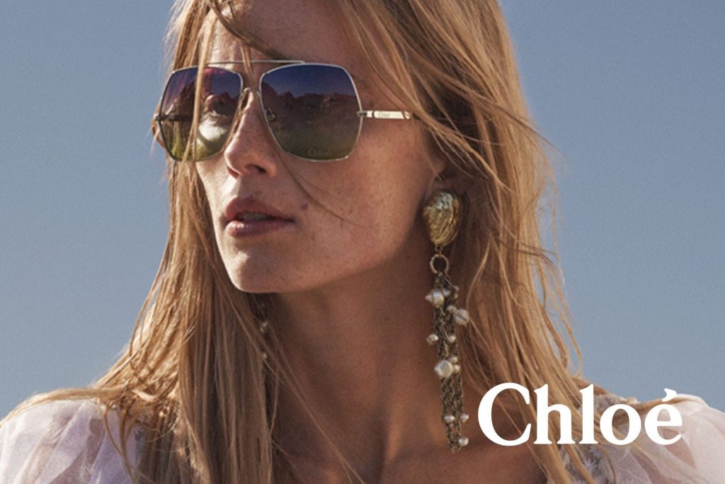 Model wearing Chloé sunglasses featuring gold double-bridge frames