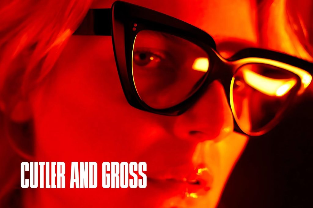 Model wearing Cutler and Gross eyeglasses featuring thick cat-eye frames