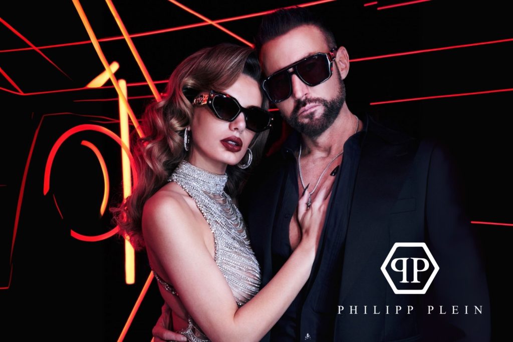 Models wearing Philipp Plein sunglasses featuring black frames and lenses