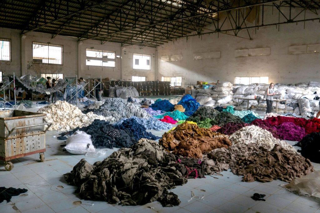 Piles of clothes in a fast-fashion clothing factory in Cambodia