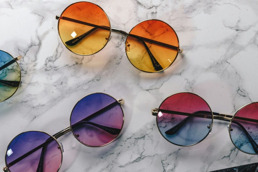 A small selection of cheap round sunglasses with rainbow gradient lenses