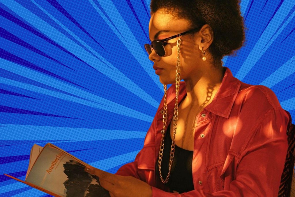 A woman reading a book while wearing sunglasses on an eyewear chain