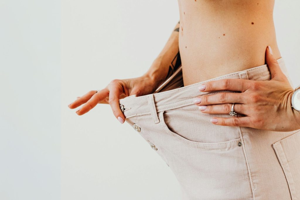 Thin woman wears pants that are too big