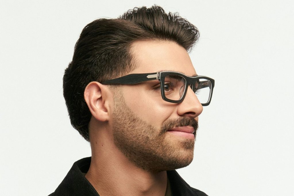 Man wearing oversized square eyeglasses featuring black frames