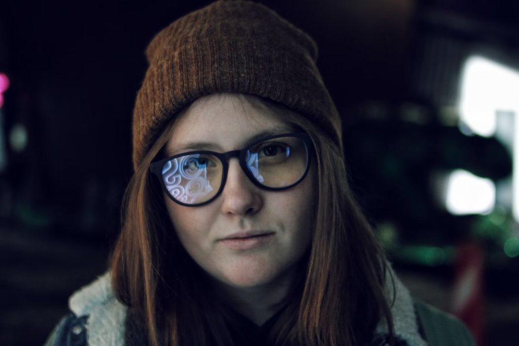 A woman wearing smart glasses with black frames