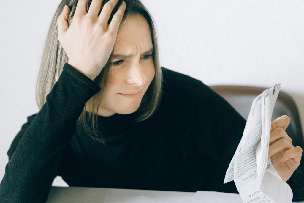 Woman in black holds documents up to read