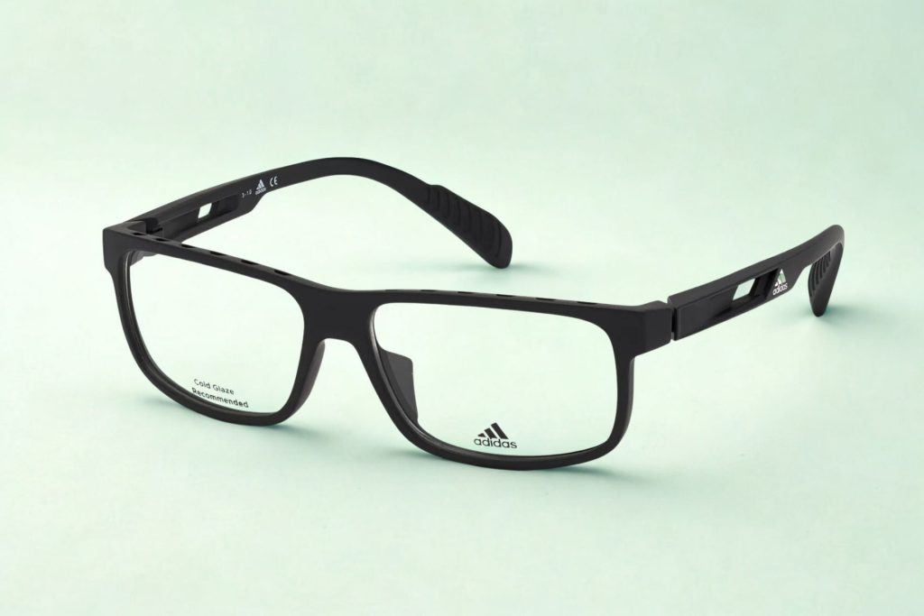 Black-framed glasses with Adidas logo on lens