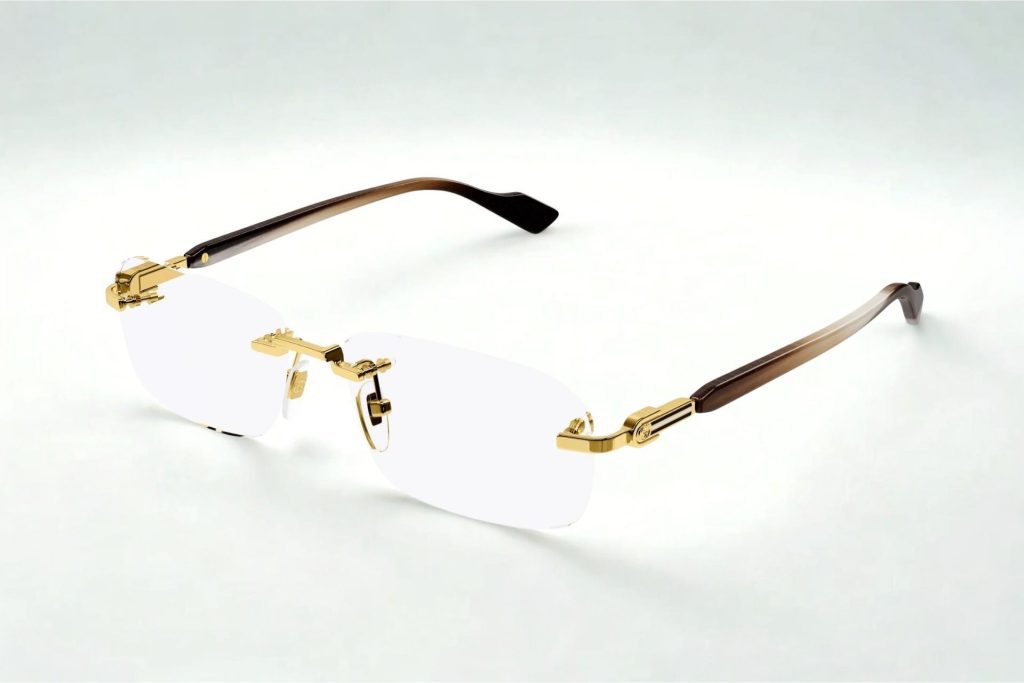 Rimless frames with gold metallic hinges and dark-hued temple arms