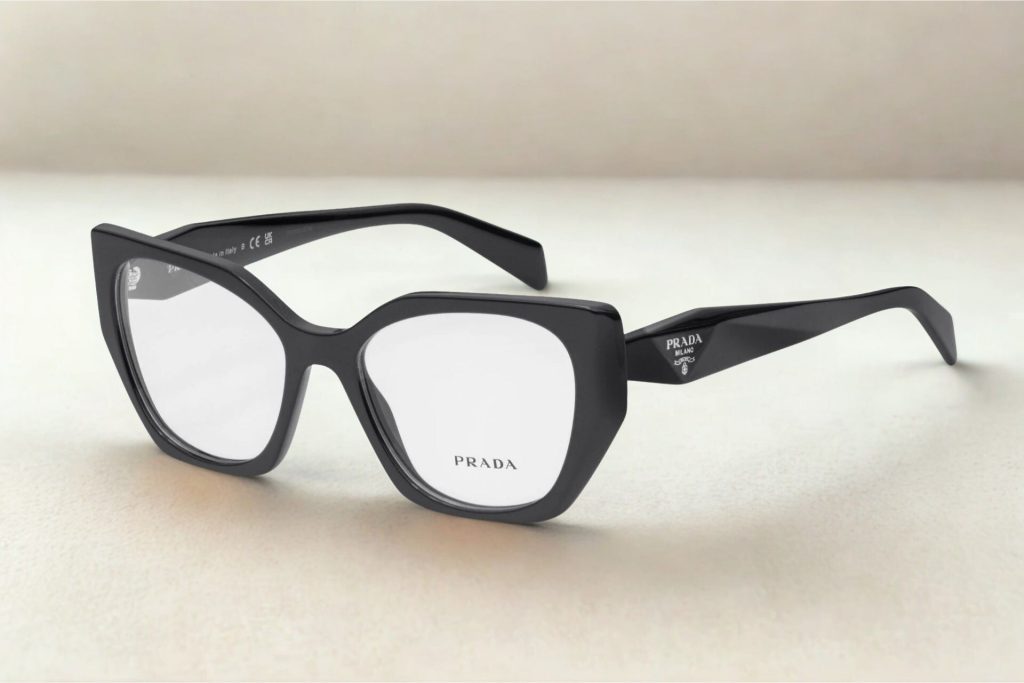Irregularly shaped black plastic frames with the Prada logo near the hinges