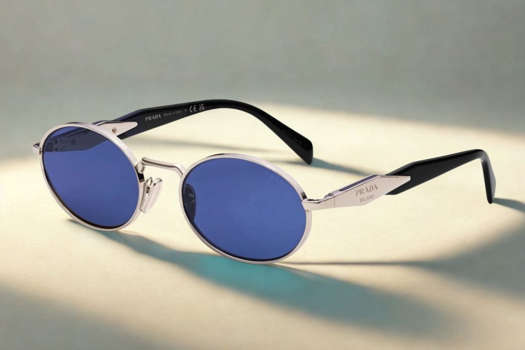 Prada PR 65ZS oval sunglasses featuring dark gray lenses