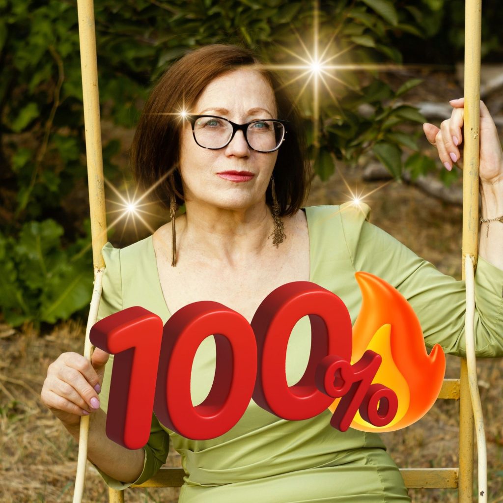 Woman wearing green dress and black glasses with 100&% written over top