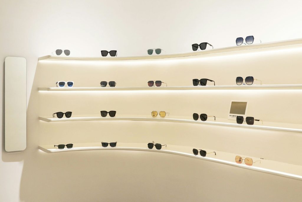 Sunglasses displayed on white shelves