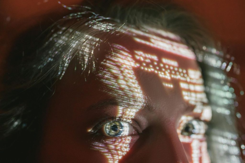 Woman’s eyes and forehead with reflected digital lights