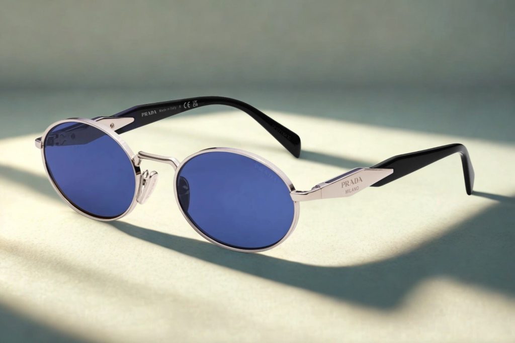 Prada PR 65ZS oval sunglasses featuring silver frames