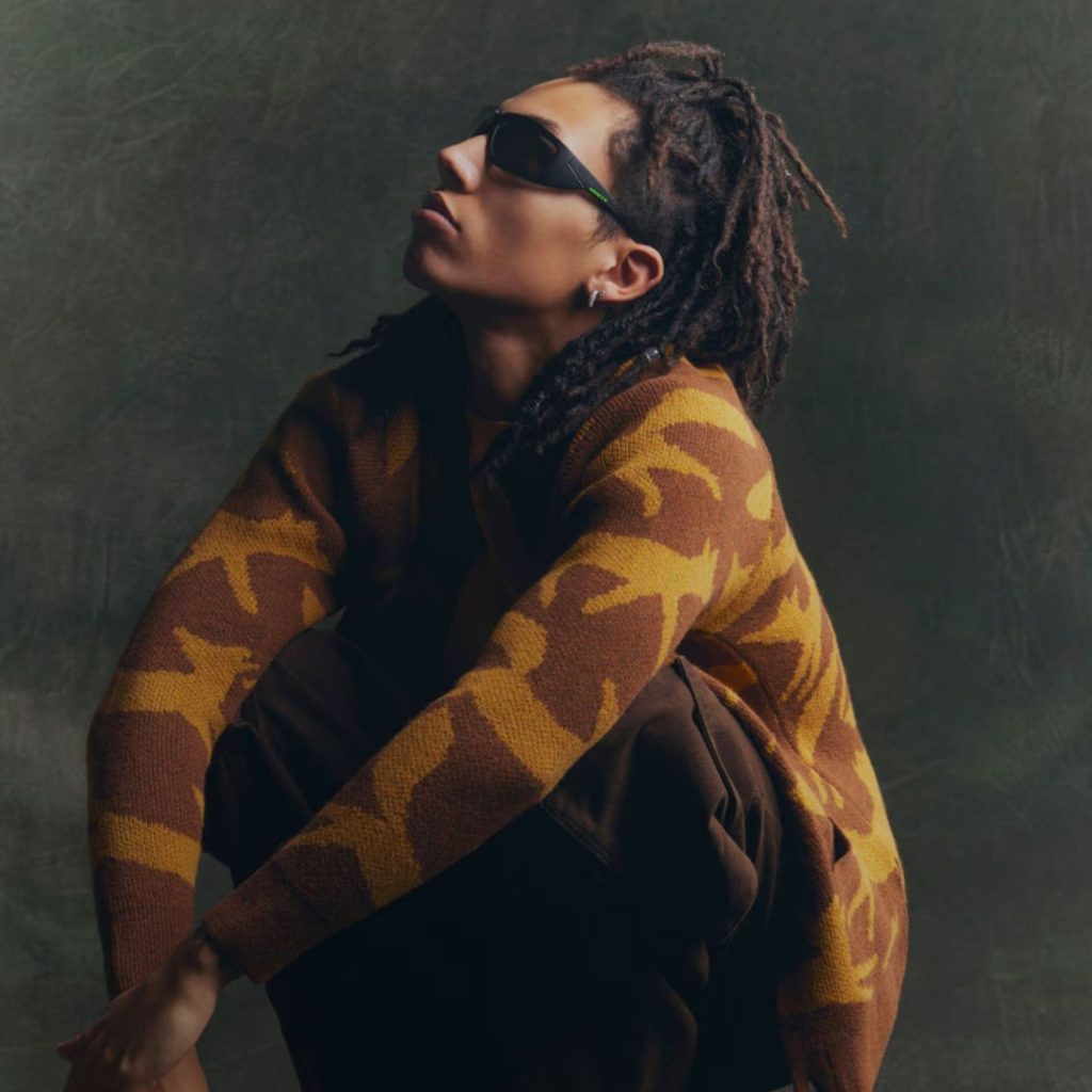 Model wearing black Arnette wrap-arond sunglasses