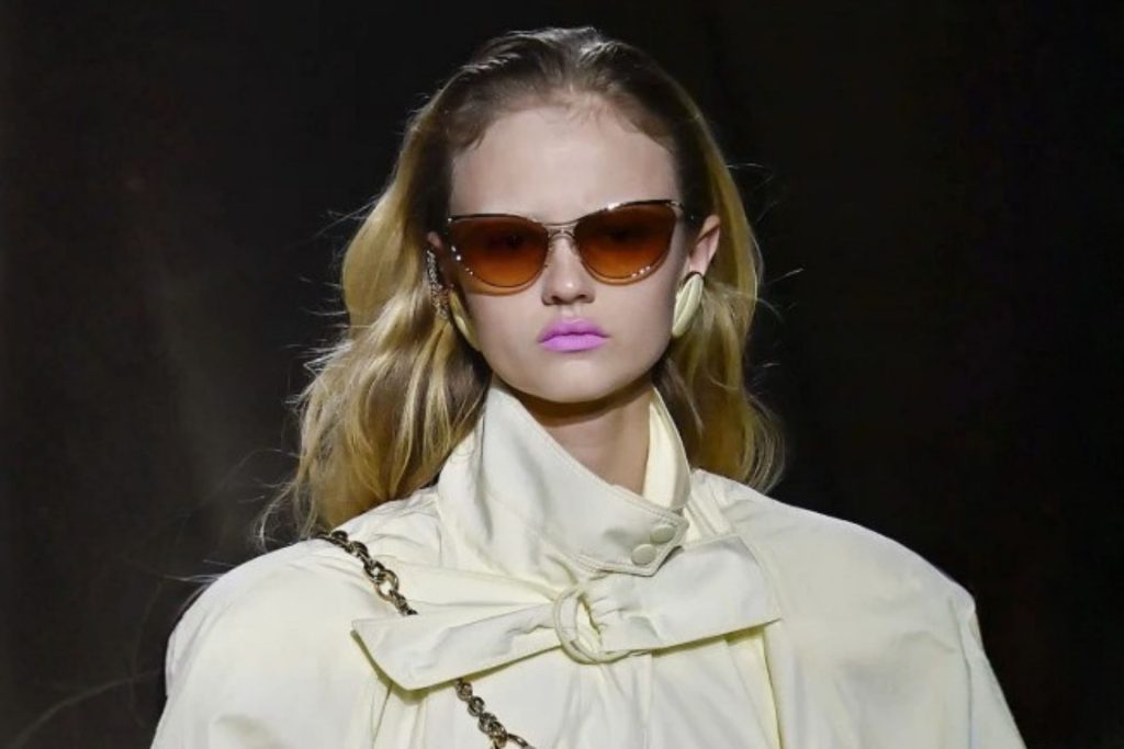 Model wearing gradient-tinted sunglasses
