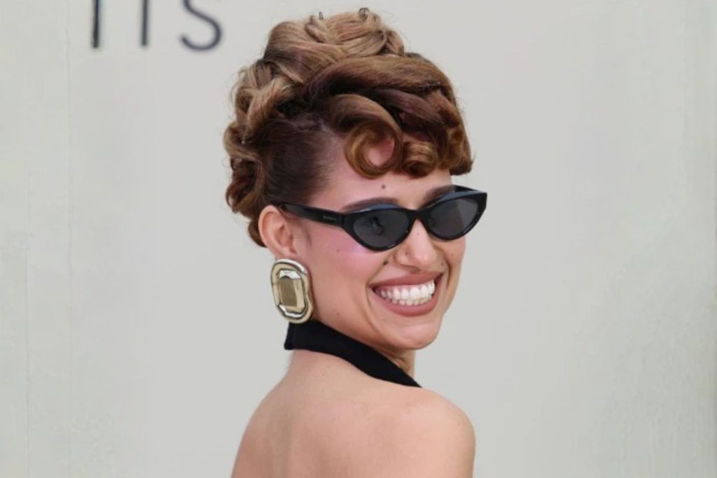 Singer Raye wearing black cat-eye sunglasses