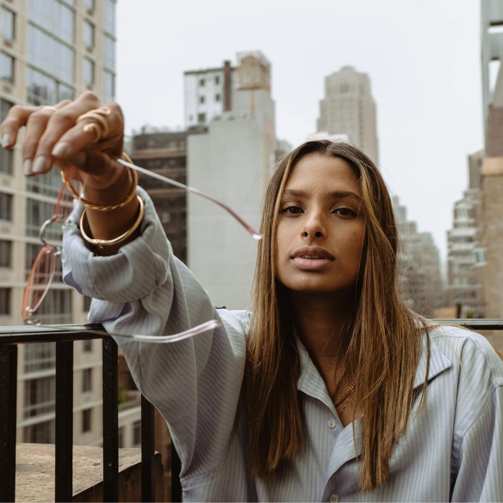Woman Holding Glasses in New York City