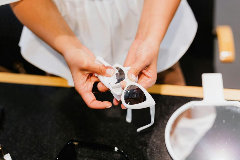 Woman uses a microfiber cloth to dry her lenses