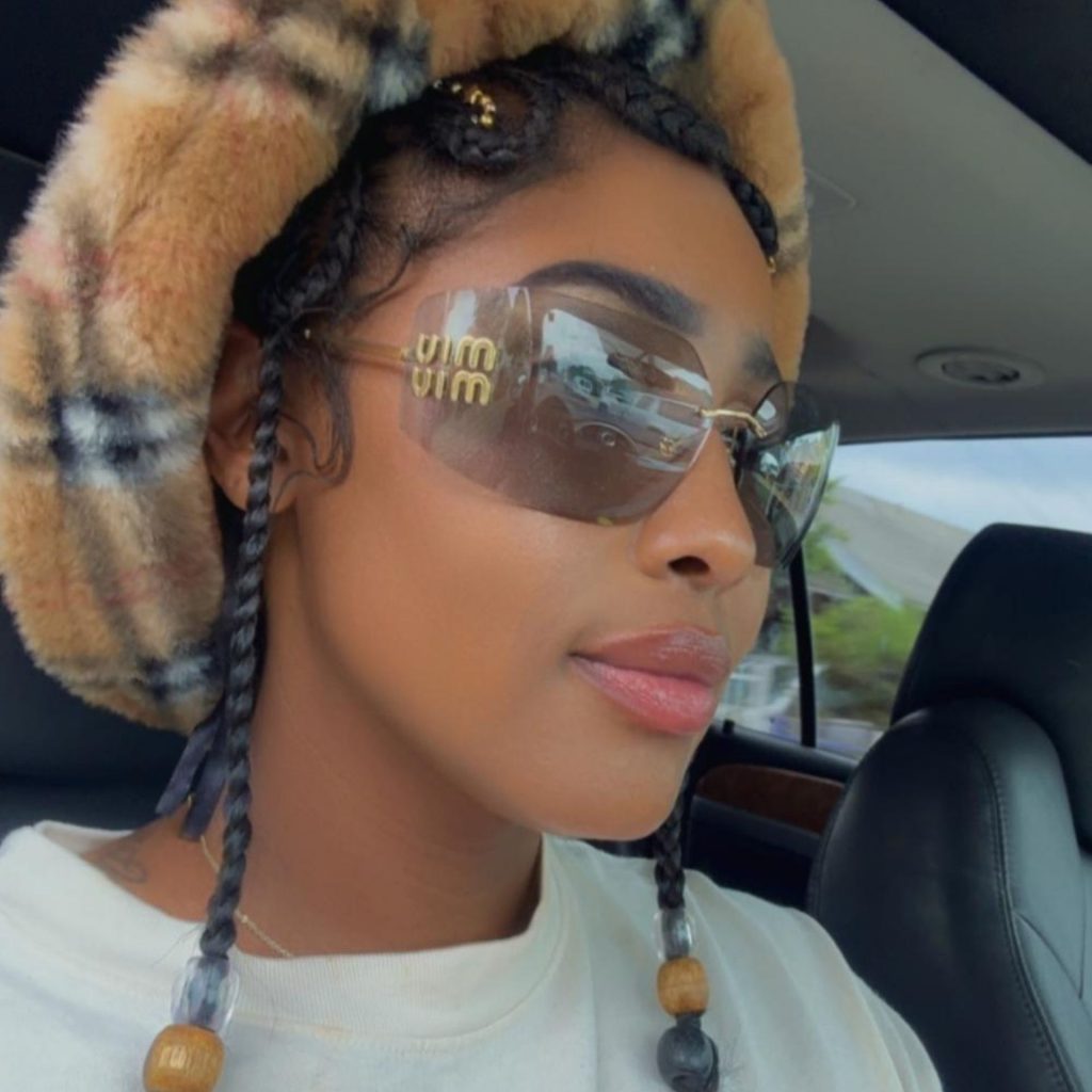 Miu Miu MU 54YS sunglasses featuring pink lenses