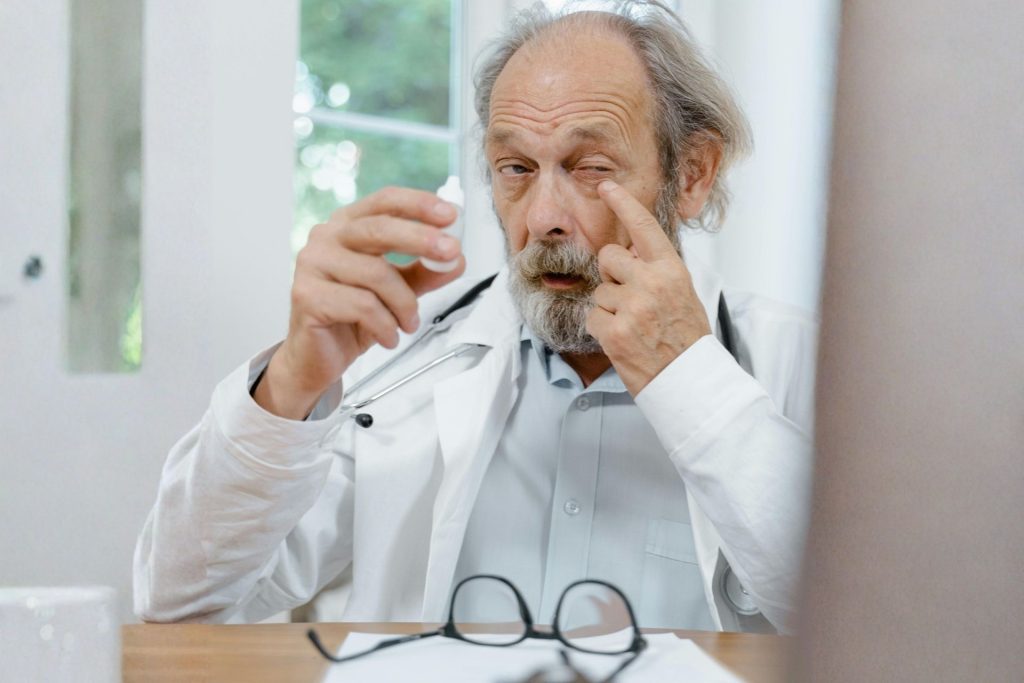 Doctor using eye drops