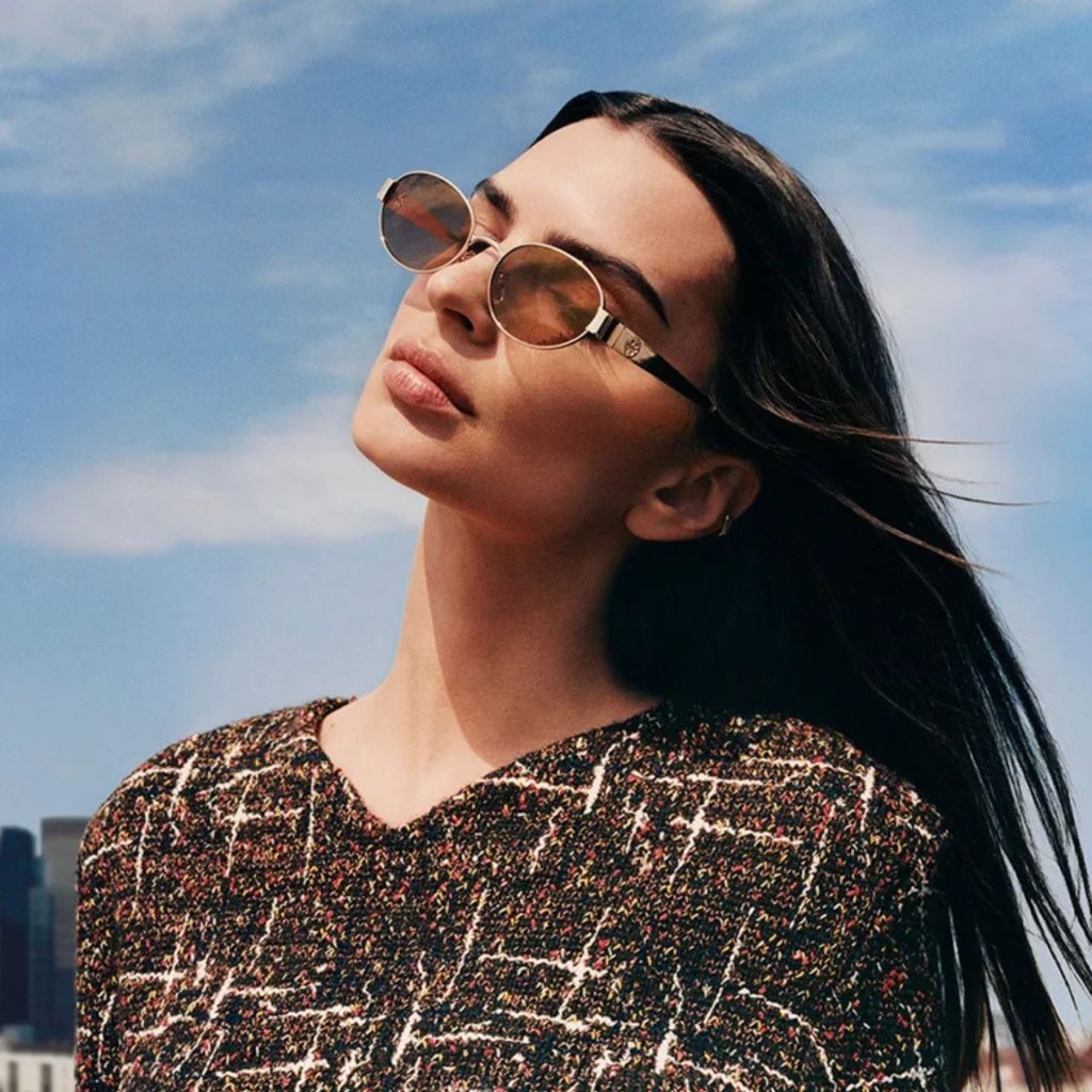 Emily Ratajkowski wearing oval gold Tory Burch sunglasses