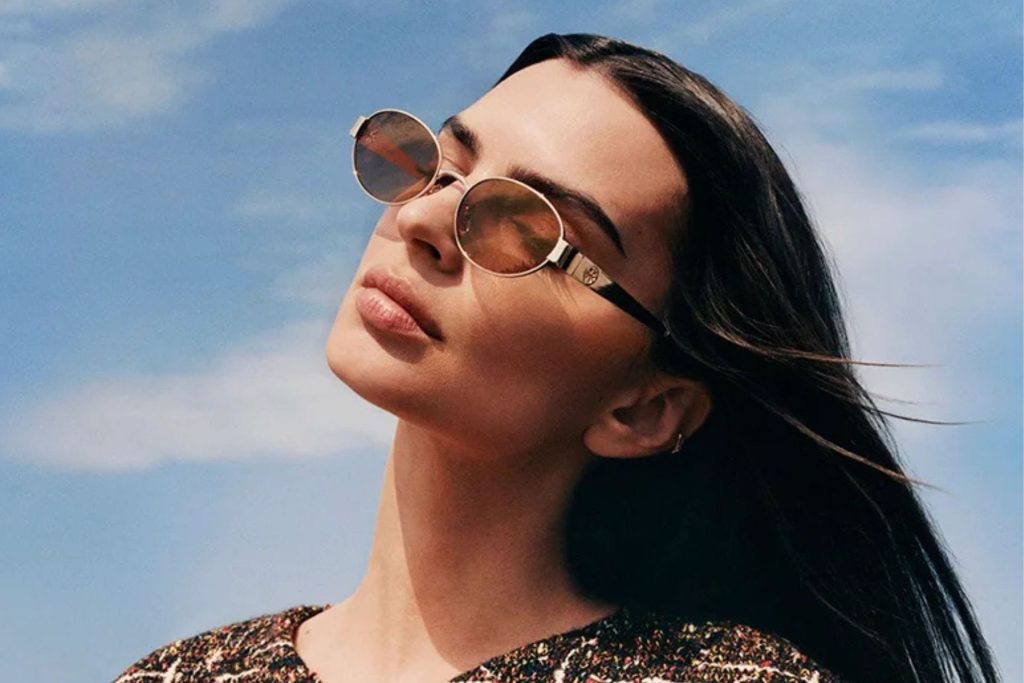 Emily Ratajkowski wearing oval gold Tory Burch sunglasses