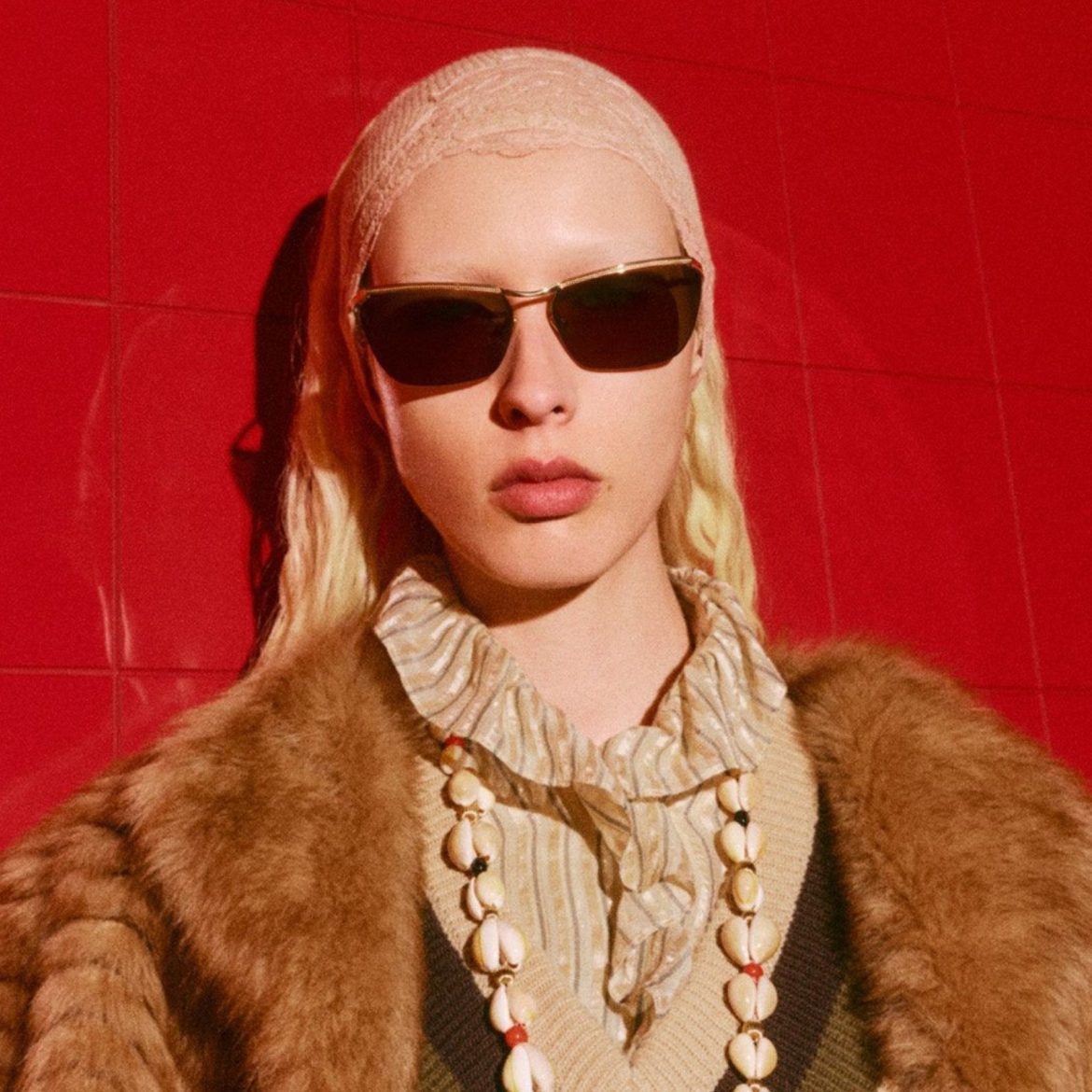 Model wearing gold and black Valentino sunglasses