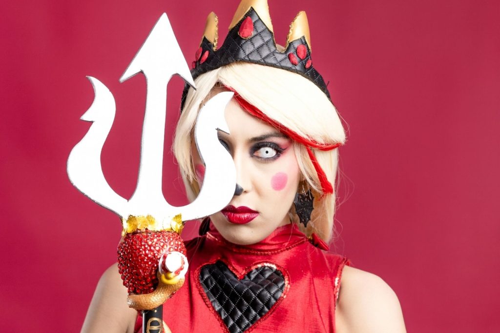 Quirky lady in a DIY devil outfit with a three-pronged crown and trident