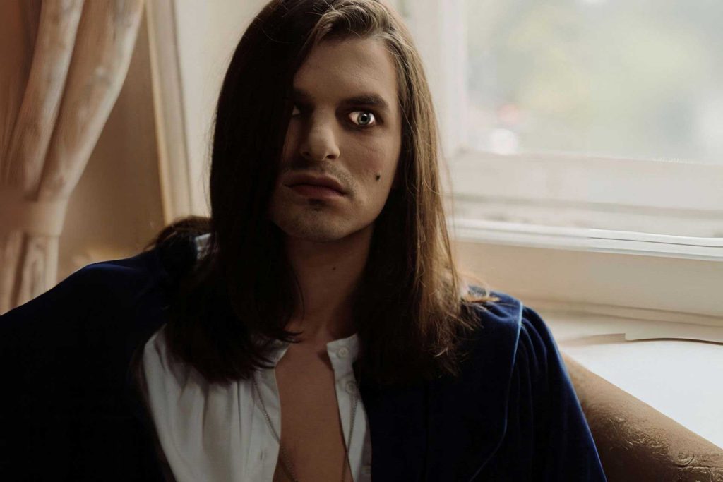 Brooding man wearing an unbuttoned shirt