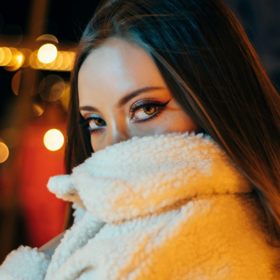 Woman wearing a fleece coat and colored contact lenses