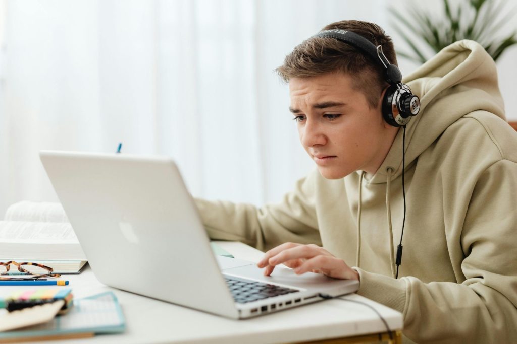 Man leans in as he works on his laptop